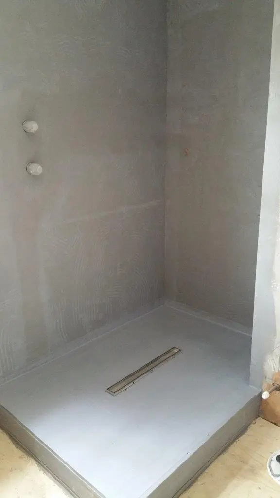 Bathroom tanking waterproof membrane system showing moisture barrier layers beneath tiles
