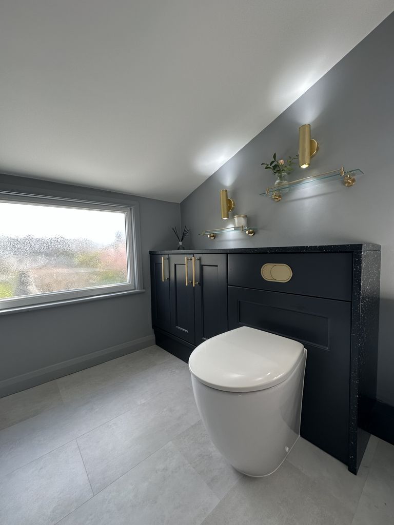 J-shape bath with brass wall lights and Ca' Pietra tiles Roper Rhodes brassware family bathroom Braintree CM7