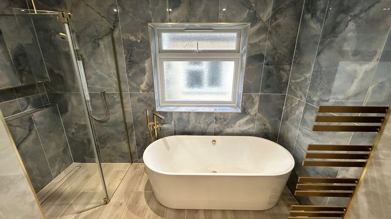 Wetroom shower area with Viado freestanding bath and floor mounted bath tap Brentwood CM13