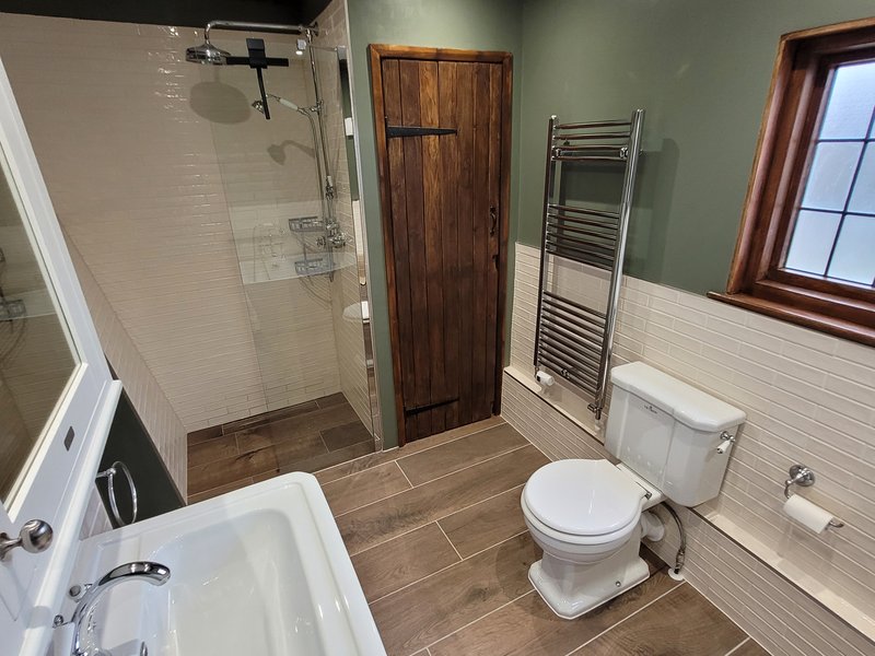 Bathroom view toward airing cupboard and WC Great Bardfield Essex integrated wetroom design