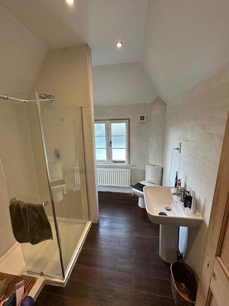 Old shower enclosure and pedestal basin before renovation, Grade 2 listed rectory Great Saling CM7 Essex