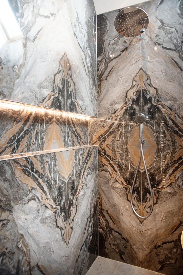 Luxury master ensuite wetroom Halstead CO9 Essex Ca Pietra Nero bookmatched tiles infinity niche IP67 lighting Bowmans